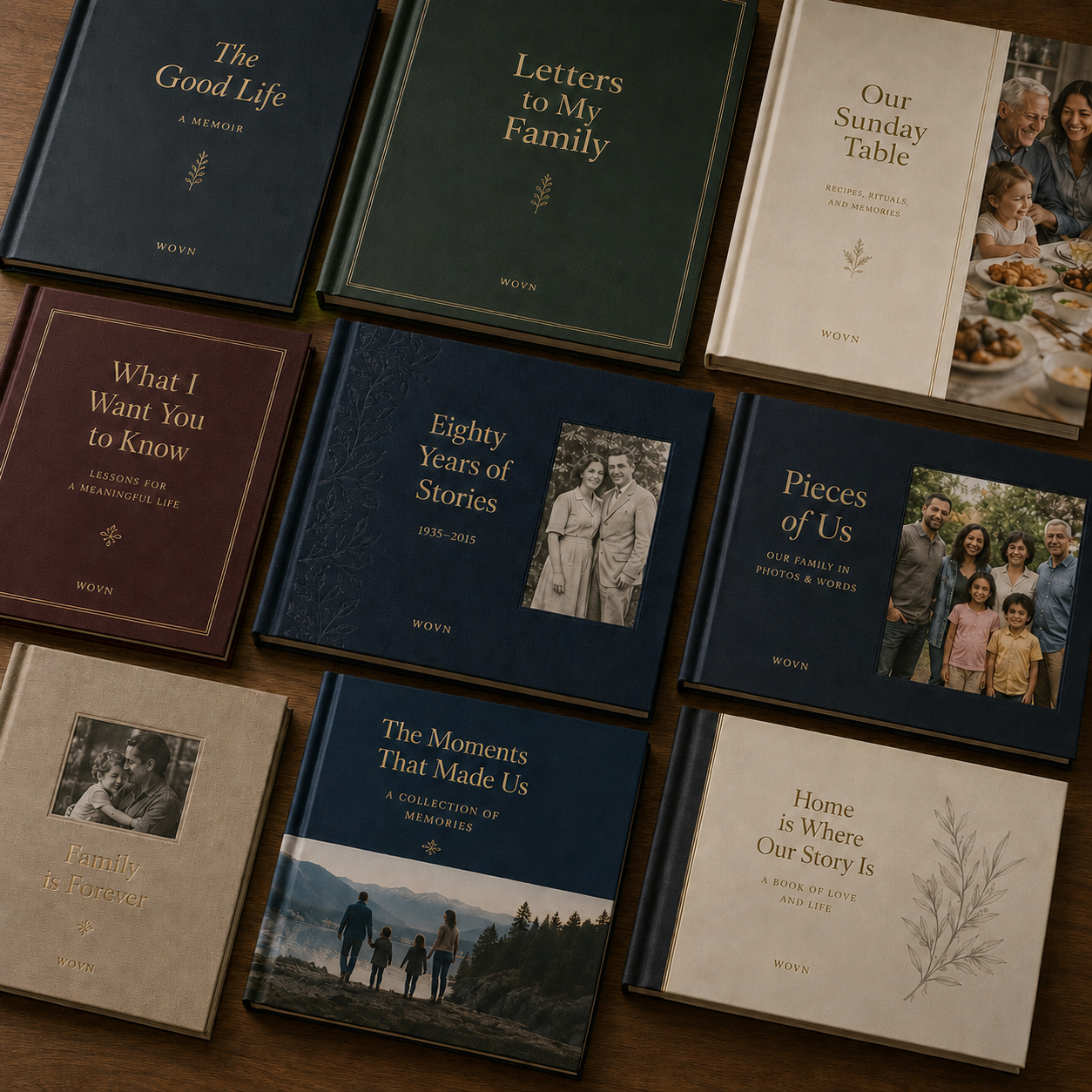 Nine keepsake book cover designs laid out on a wood table